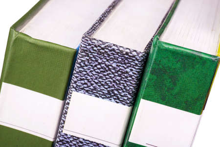 Three books shot close-up on a shelf