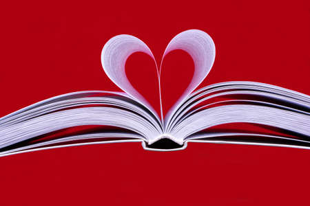 Heart of the pages of an open book on a red background