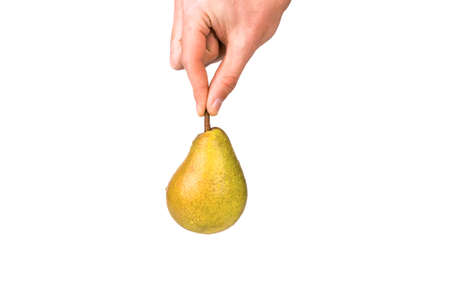Man with two fingers holds pear stalkの写真素材