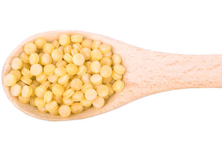 Wooden spoon filled with couscousの写真素材