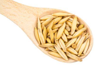 Full wooden spoon with oats closeupの写真素材