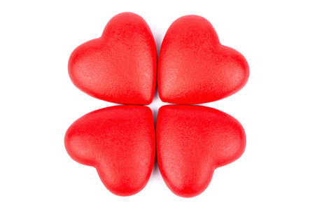 Four red heart made of plastic in the form of a flowerの写真素材