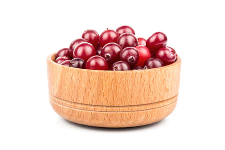 Wooden bowl full of ripe red cranberries on white backgroundの写真素材
