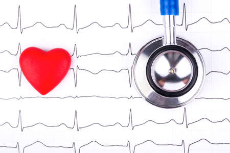 Medical stethoscope to listen to the lungs with a small red heart on the cardiogram