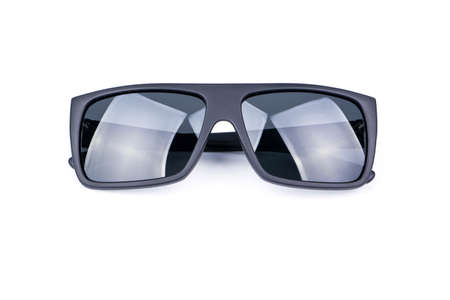 Black protective sun glasses folded on a white background