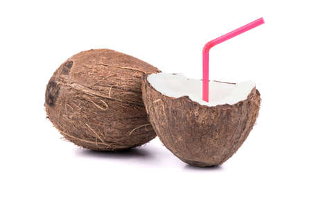 Full coconut fruit with half in which the cocktail with a straw to drink