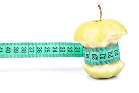 Apple core wrapped in meter symbolizing Diet and Weight Lossの写真素材