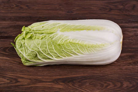 Fresh ripe chinese cabbage on a brown wooden backgroundの写真素材