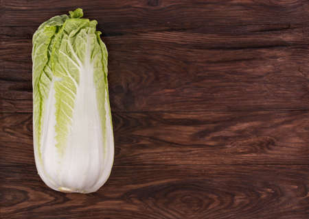 Fresh ripe chinese cabbage on a brown wooden backgroundの写真素材