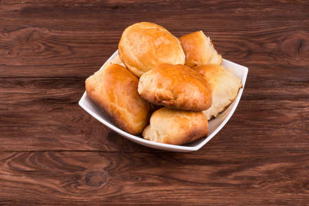 Full bowl of homemade pie on a wooden backgroundの写真素材