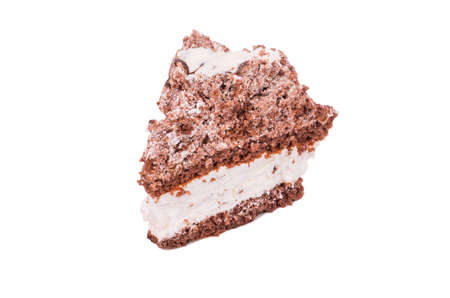 A piece of chocolate cake with cream on a plate on a white backgroundの写真素材