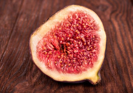 Cut in half fresh figs closeup on a wooden tableの写真素材