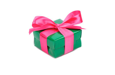 Little green box with a pink ribbon for a gift on a white backgroundの写真素材