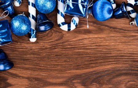 Various Christmas toys on the tree on an empty wooden backgroundの写真素材