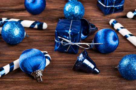 Scattered variety of Christmas toys on fir tree on a wooden background closeupの写真素材
