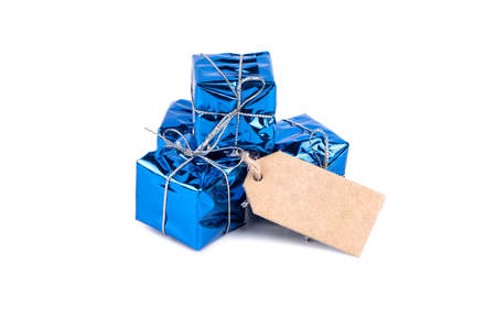 Several small blue boxes with gifts with a label for price or discount on a white backgroundの写真素材