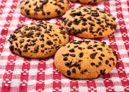 Several cookies with chocolate close-up on a kitchen towel
