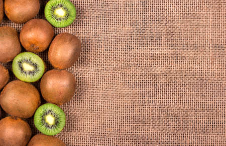 Scattered kiwi fruit on a blank sackingの写真素材