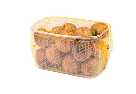 Fruit kiwi in transparent plastic bag with a netting on a white backgroundの写真素材