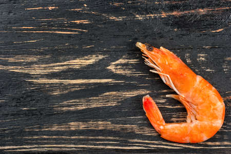 Boiled shrimp on an empty wooden background, top viewの写真素材