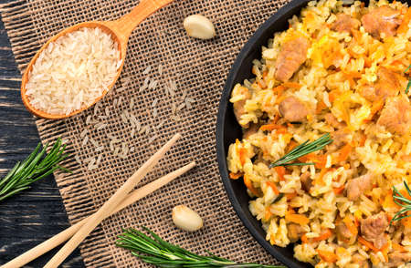 Freshly prepared delicious Asian pilaf with condiments on the table, top viewの写真素材