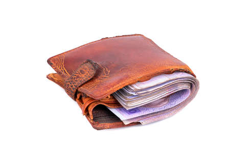 Old used wallet filled Ukrainian money on a white background