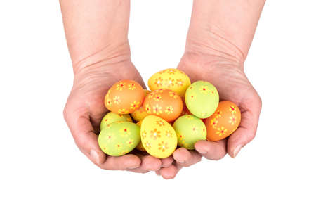 Woman holding multicolored Easter eggs with flower pattern on a white background