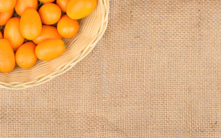 Part of the kumquat fruit baskets on an empty sackclothの写真素材