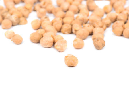 Scattered grains of dry chickpeas on a white backgroundの写真素材