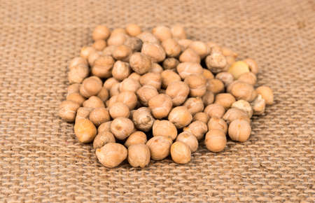 Pile of dried chickpeas on sackingの写真素材