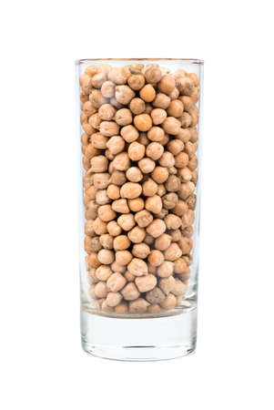 Glass filled with dry chickpeas on a white backgroundの写真素材