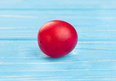 Fresh red cherry plum on wooden background