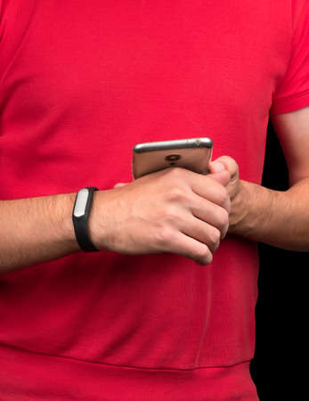 Young athlete synchronizes fitness bracelet with smartphoneの写真素材