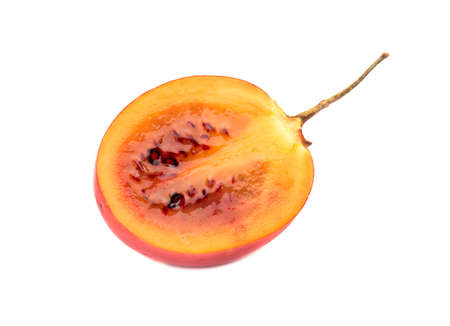 Juicy half of the fruit tamarillo isolated on white background