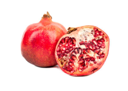 Ripe fruit with a juicy pomegranate half on a white backgroundの写真素材