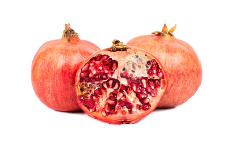 Fresh pomegranate with a juicy half on a white backgroundの写真素材