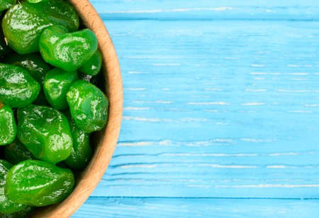 Some bowls with dried green kumquat on an empty wooden backgroundの写真素材