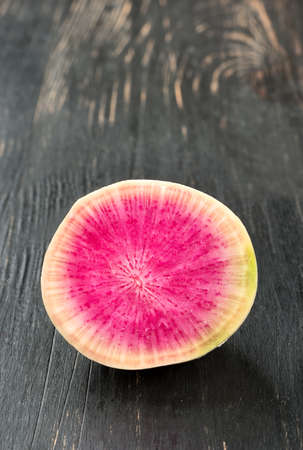 Fresh half of watermelon radish on wooden backgroundの写真素材