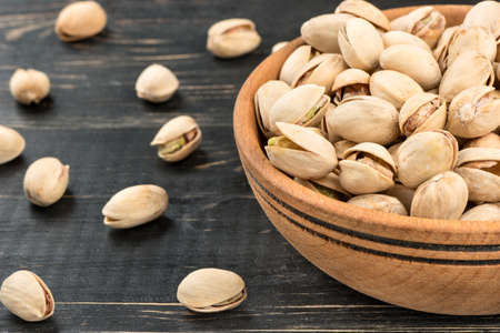 Part bowls with salty pistachio nuts on the table