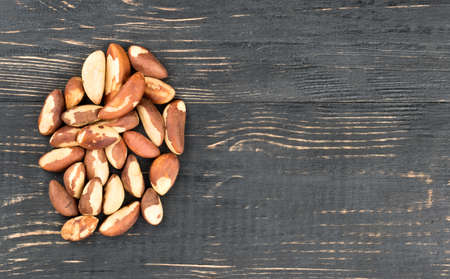 Bunch of Brazil nuts on an empty wooden background, top viewの写真素材