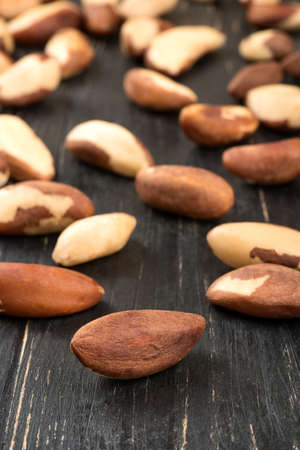 Brazil nuts are scattered on wooden backgroundの写真素材