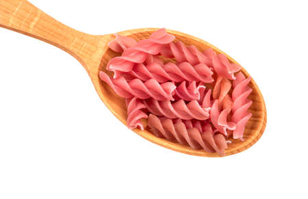 Red fusilli pasta in spoon on white background, closeupの写真素材