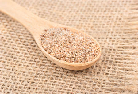 Spoon with the spice of nutmeg on sackcloth close upの写真素材