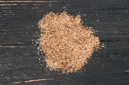 Bunch of nutmeg powder on wooden background, top viewの写真素材