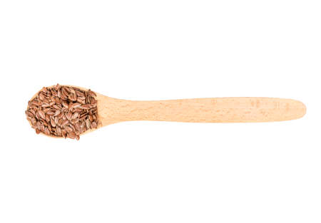 Flax seeds in wooden spoon isolated on white background, top viewの写真素材