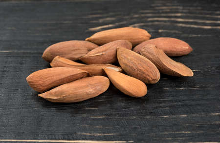 Small bunch of Uzbek almonds without shell on wooden backgroundの写真素材