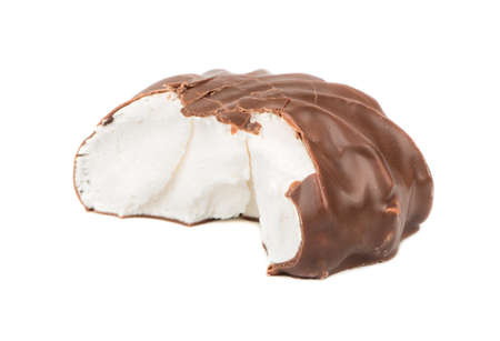 Bitten off a delicious marshmallow in chocolate on a white backgroundの写真素材