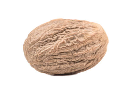 Dry nutmeg isolated on white background closeup