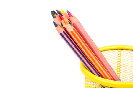 Colored pencils in a metal basket on white backgroundの写真素材
