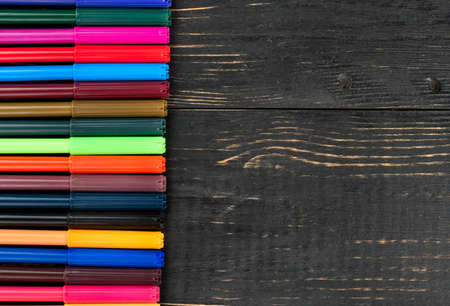 Lot of colorful markers on wooden background, top viewの写真素材
